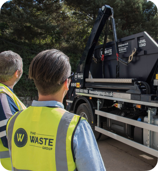 waste group employees loading a skip